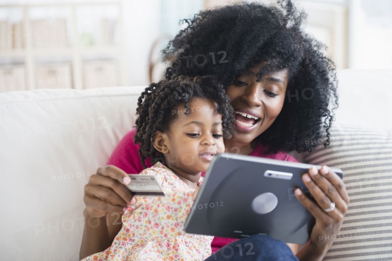 Mother and daughter shopping on tablet computer