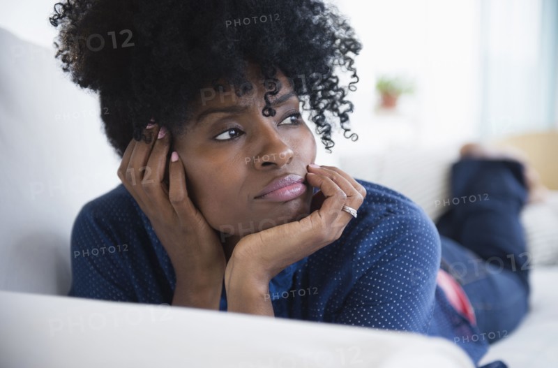 Black woman laying on sofa
