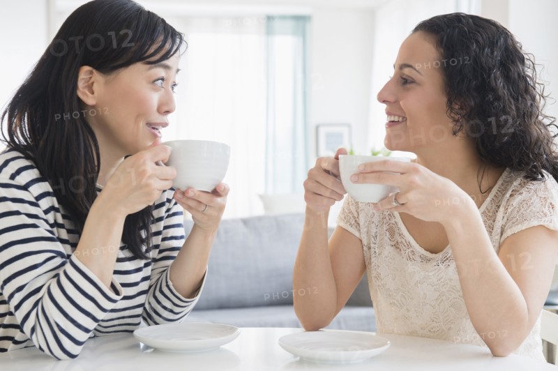 Women drinking coffee together at table
