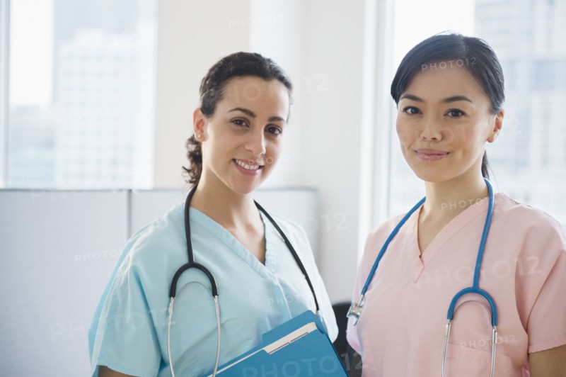 Nurses smiling together in hospital