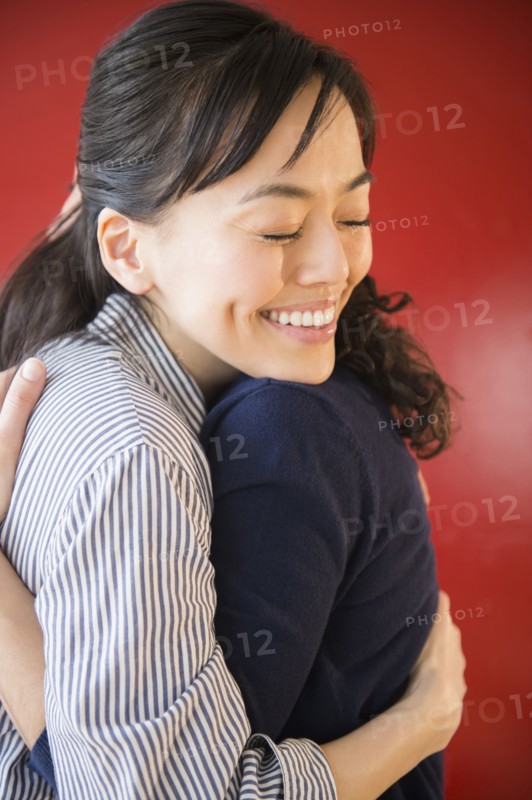 Smiling women hugging