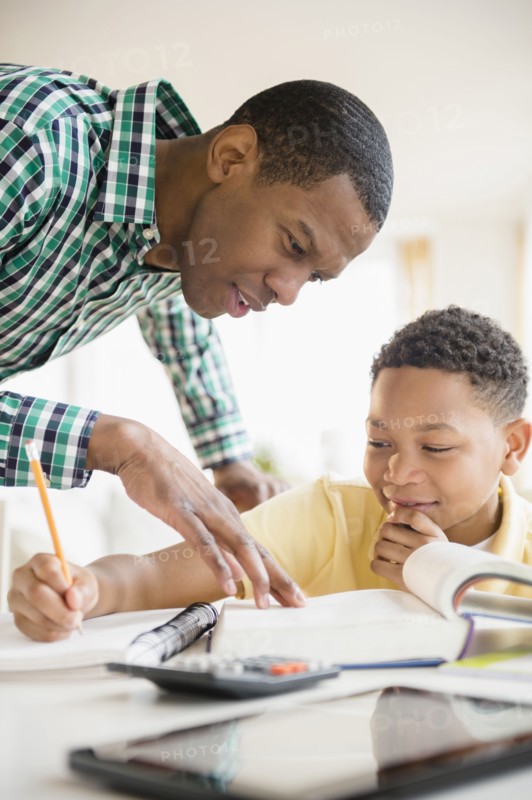 Father helping son with homework