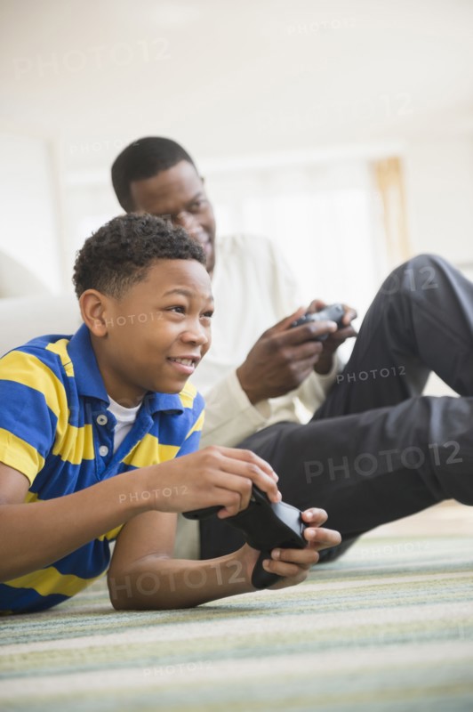 Father and son playing video games together