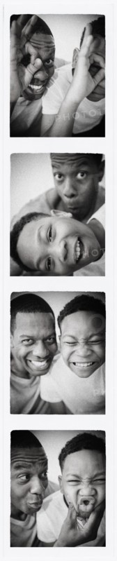Father and son smiling in photo booth picture