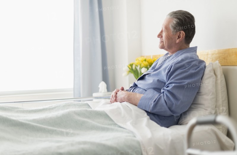 Senior Caucasian man sitting in hospital bed