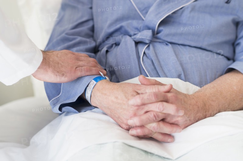 Caucasian doctor reassuring patient in hospital