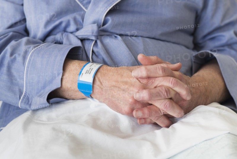 Senior Caucasian man sitting in hospital bed