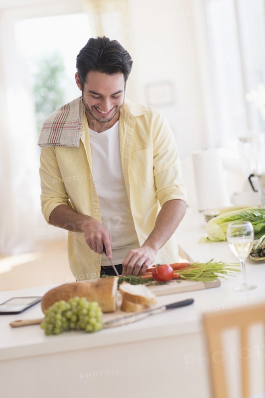 Mixed race man cooking in kitchen