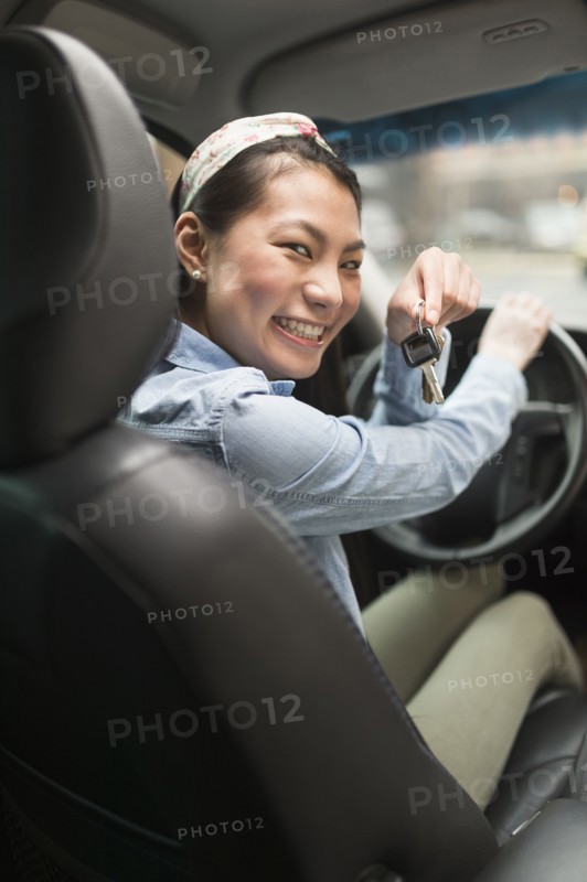Mixed race teenage girl holding keys to car