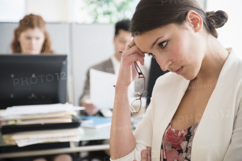 Businesswoman scratching her head in office