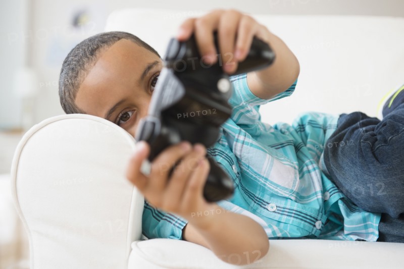 Mixed race boy playing video games