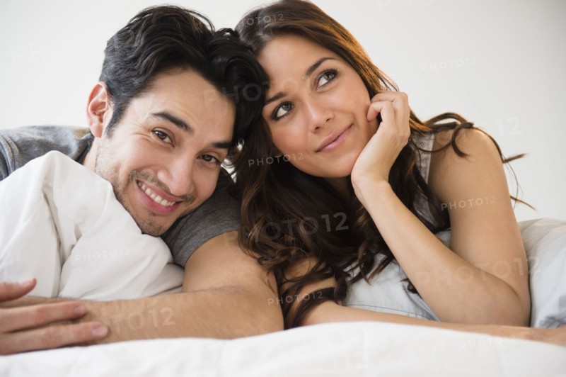 Couple relaxing together in bed