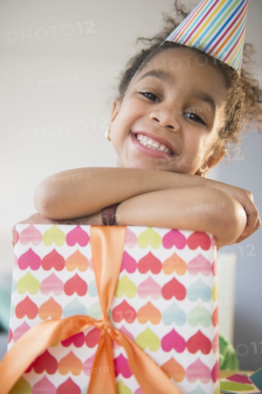 African American girl holding wrapped birthday gift