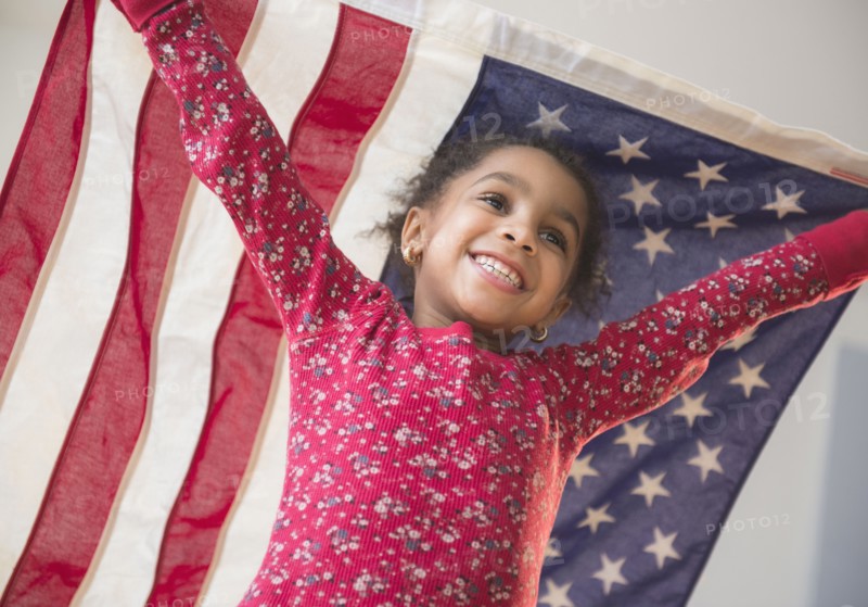 African American girl playing with United States flag