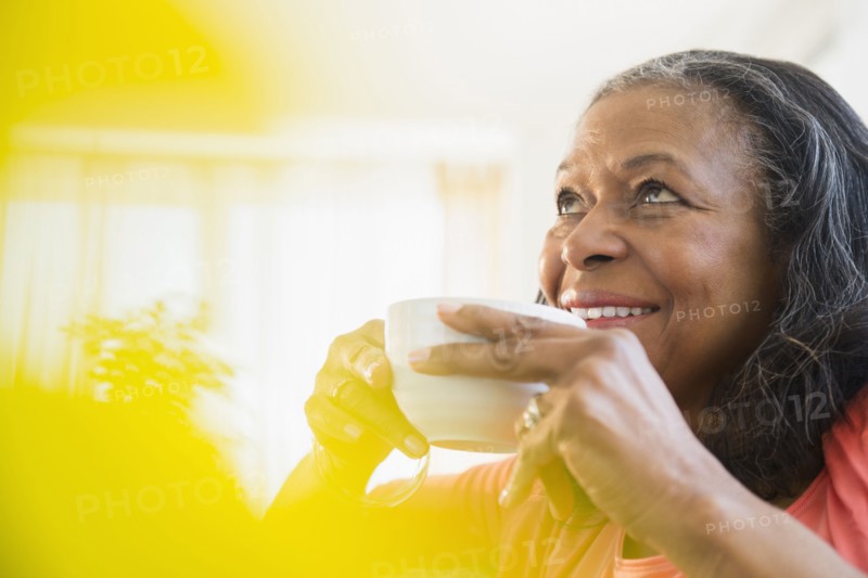 Mixed race woman drinking cup of coffee