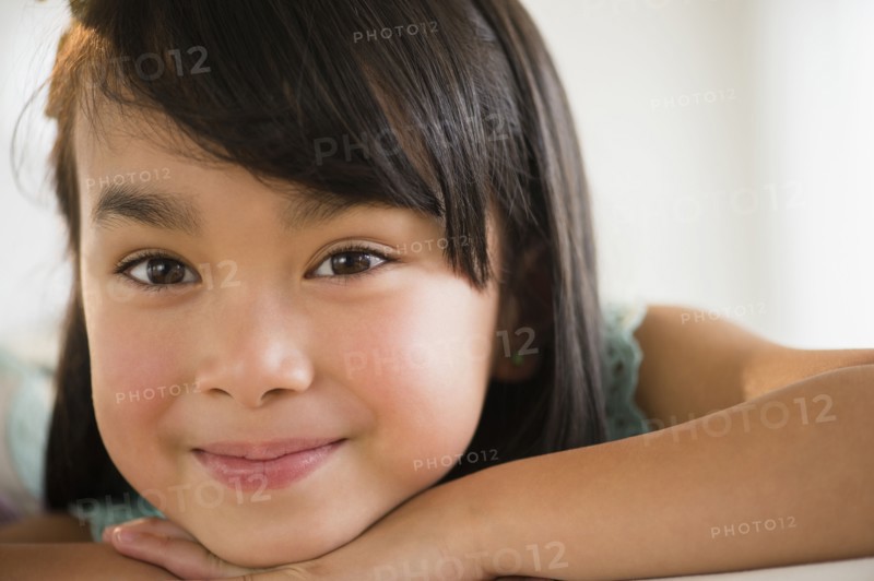 Filipino girl resting chin in hands