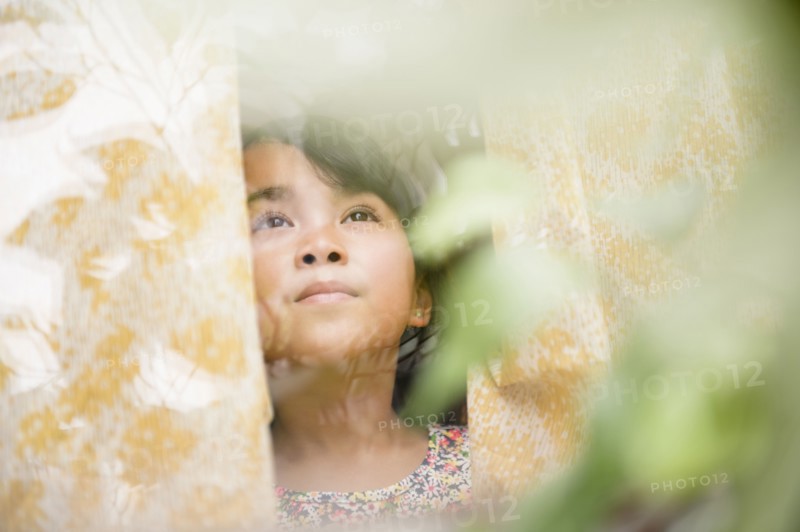 Filipino girl looking out window
