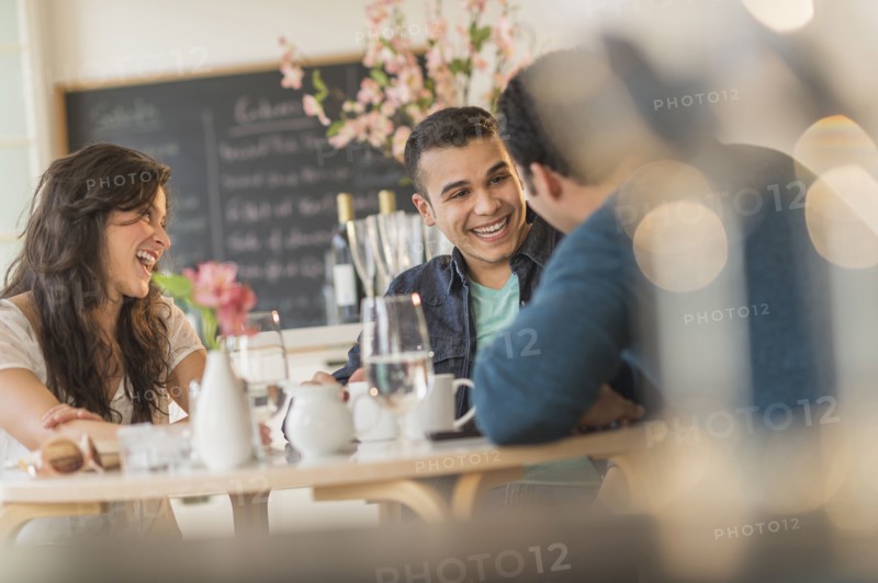 Hispanic friends talking in cafe
