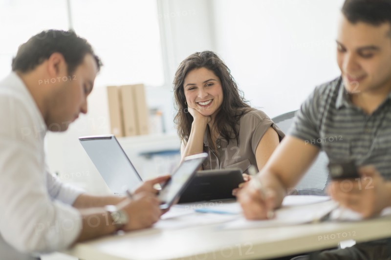 Hispanic business people working in office