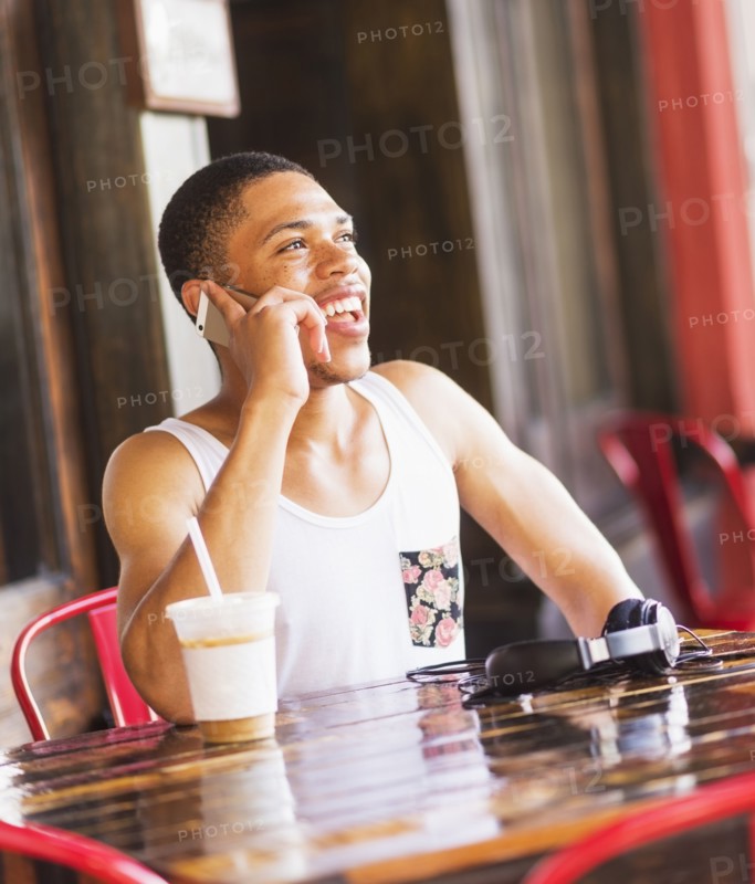 African American man talking on cell phone at cafe