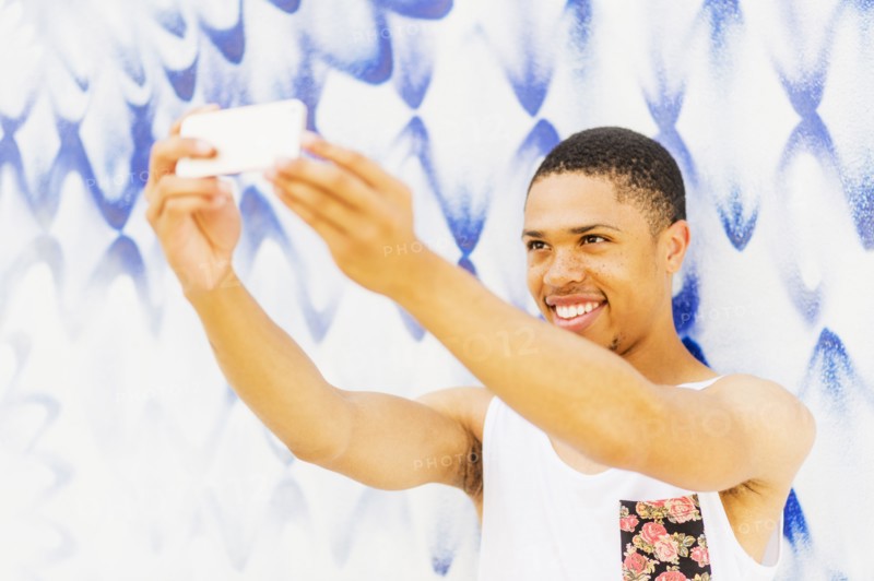 African American man taking cell phone pictures