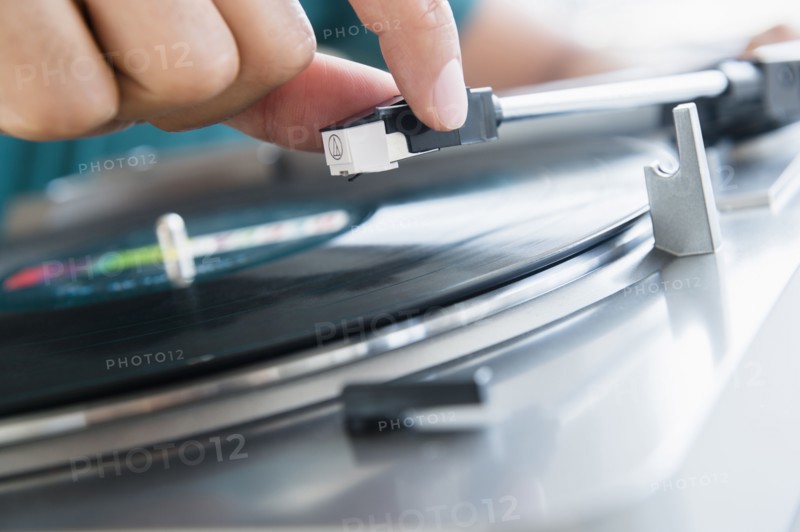 Close up of mixed race man playing vinyl record