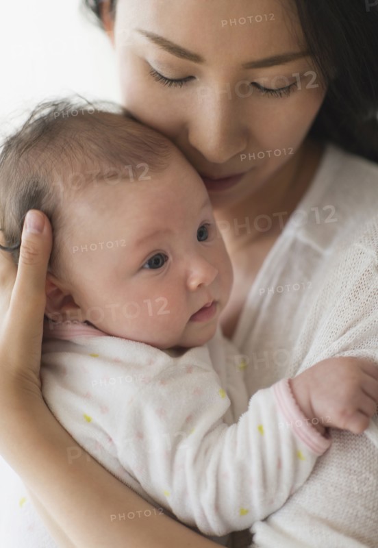 Asian mother holding baby