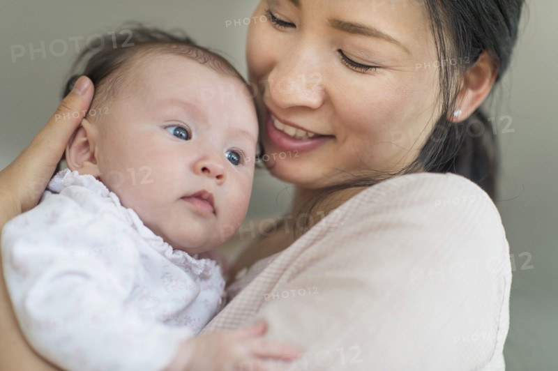 Asian mother holding baby