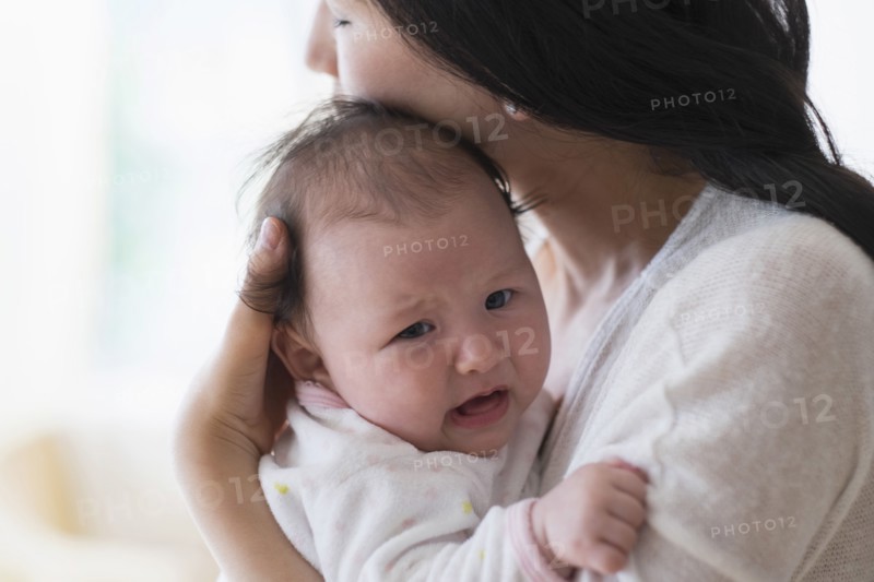 Asian mother comforting crying baby