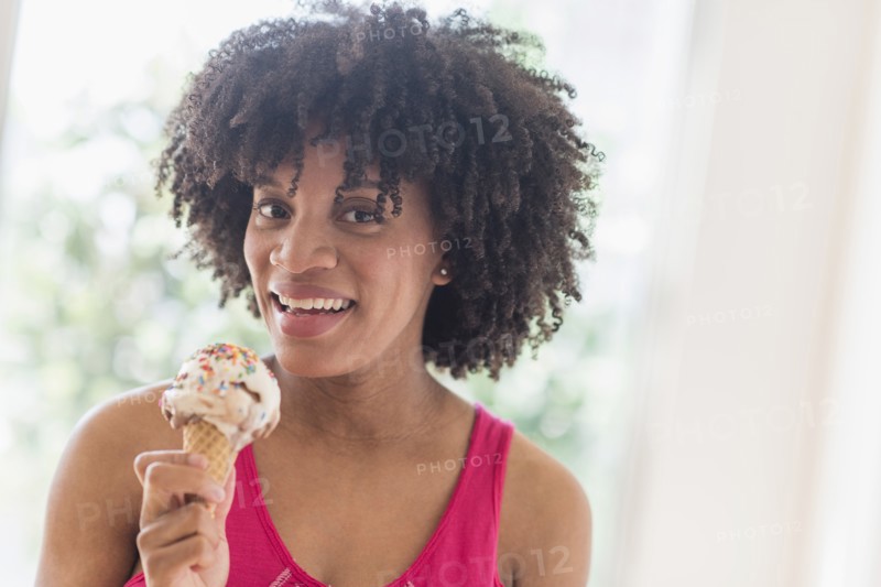 African American woman eating ice cream cone