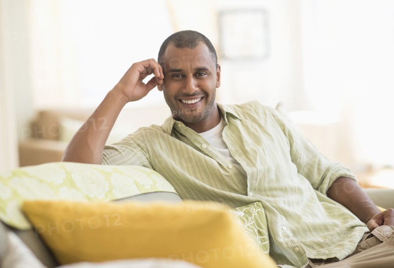 Mixed race man smiling in living room