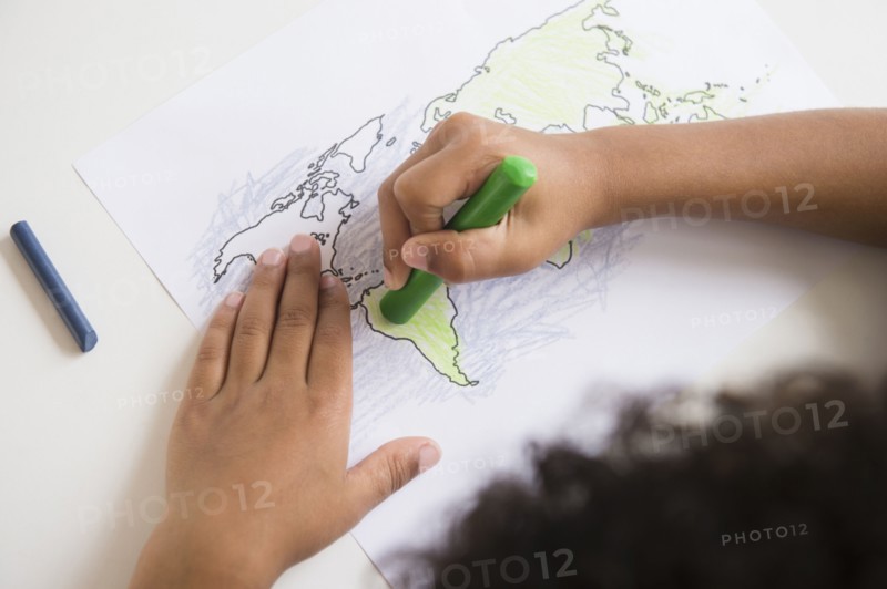 Mixed race boy coloring in world map