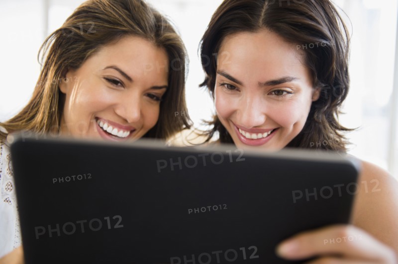 Hispanic women using digital tablet