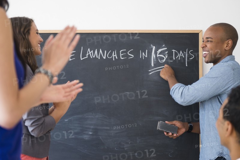 Business people cheering and preparing for launch in office