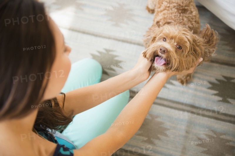Caucasian woman petting dog