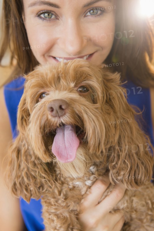 Caucasian woman holding pet dog