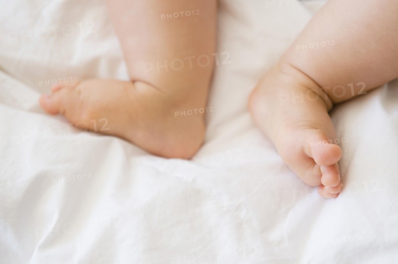 Close up of feet of mixed race baby