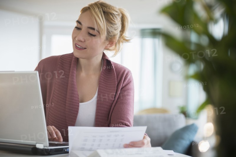 Caucasian woman paying bills online