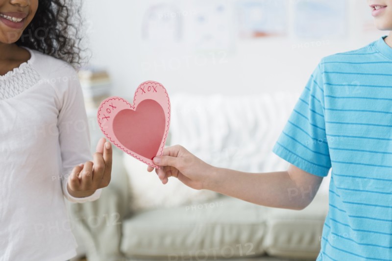 Boy passing Valentine to friend