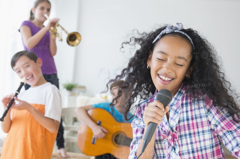 Happy children singing and playing music
