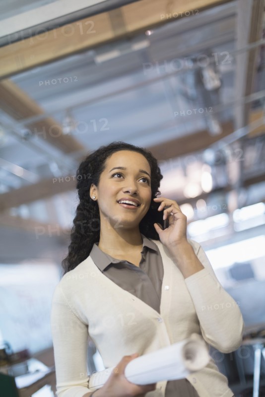 Mixed race architect talking on cell phone