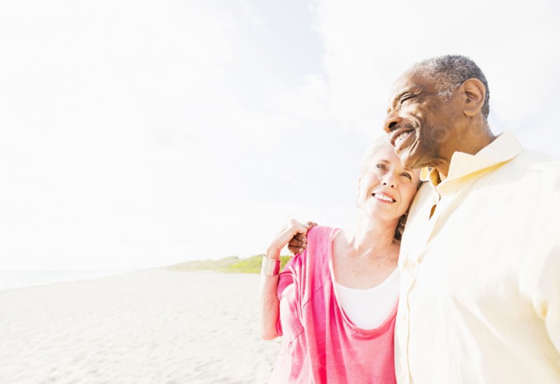 Older couple hugging on beach