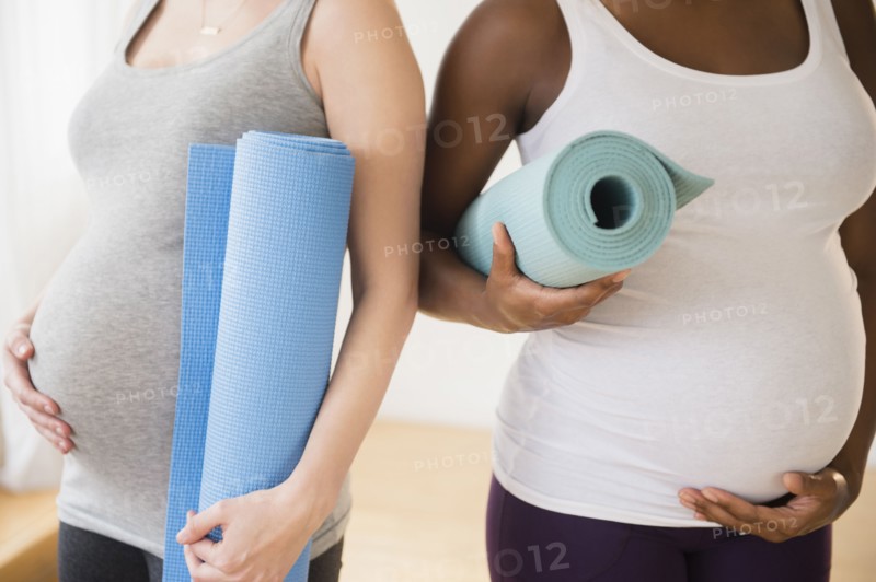 Pregnant women carrying yoga mats