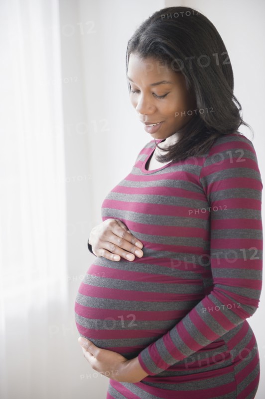 Black pregnant woman admiring her stomach