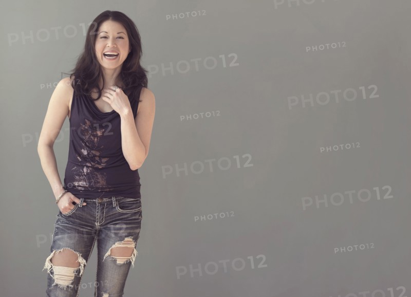 Mixed race woman wearing ripped jeans