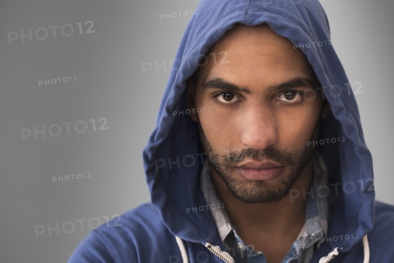 Serious Hispanic man wearing hoodie