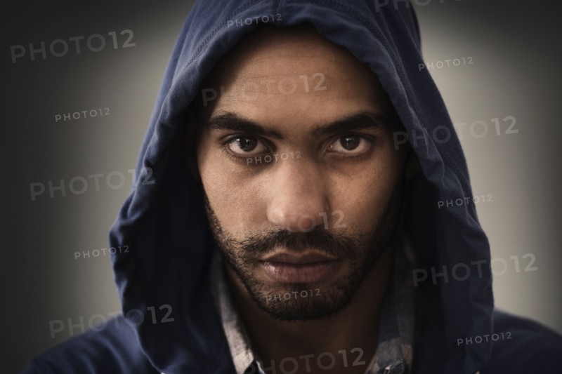 Serious Hispanic man wearing hoodie