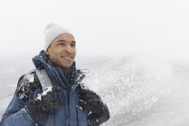 Black man hiking in snow