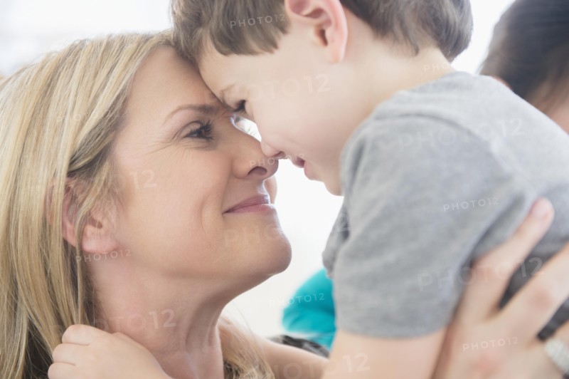 Close up of Caucasian mother and son touching forehead