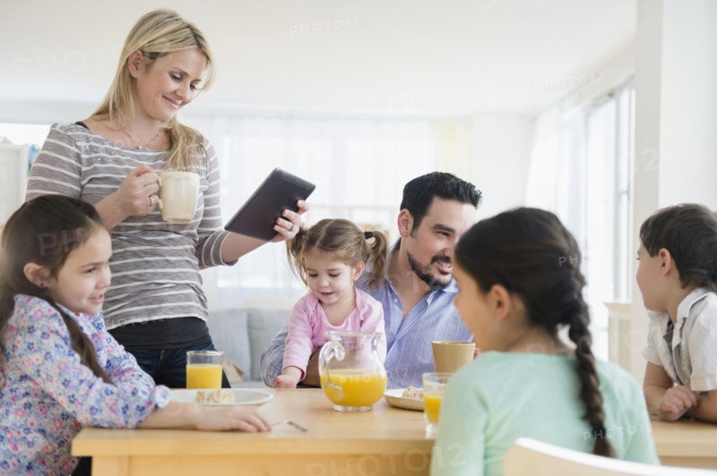 Caucasian family eating breakfast at table